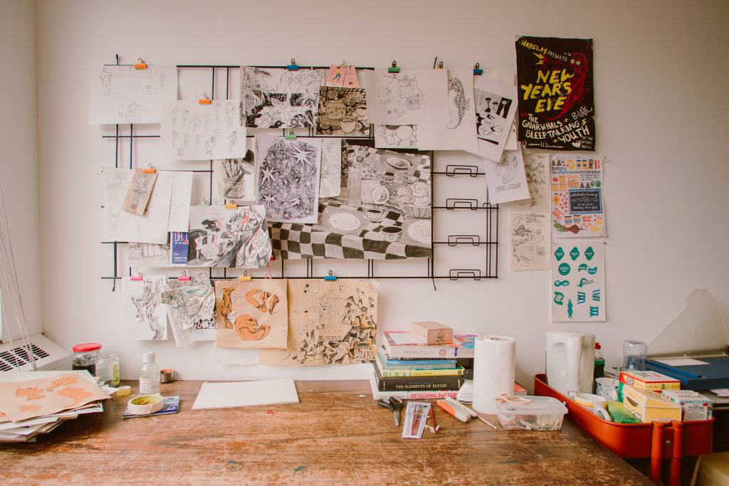 Creative workspace with artwork stuck onto the wall
