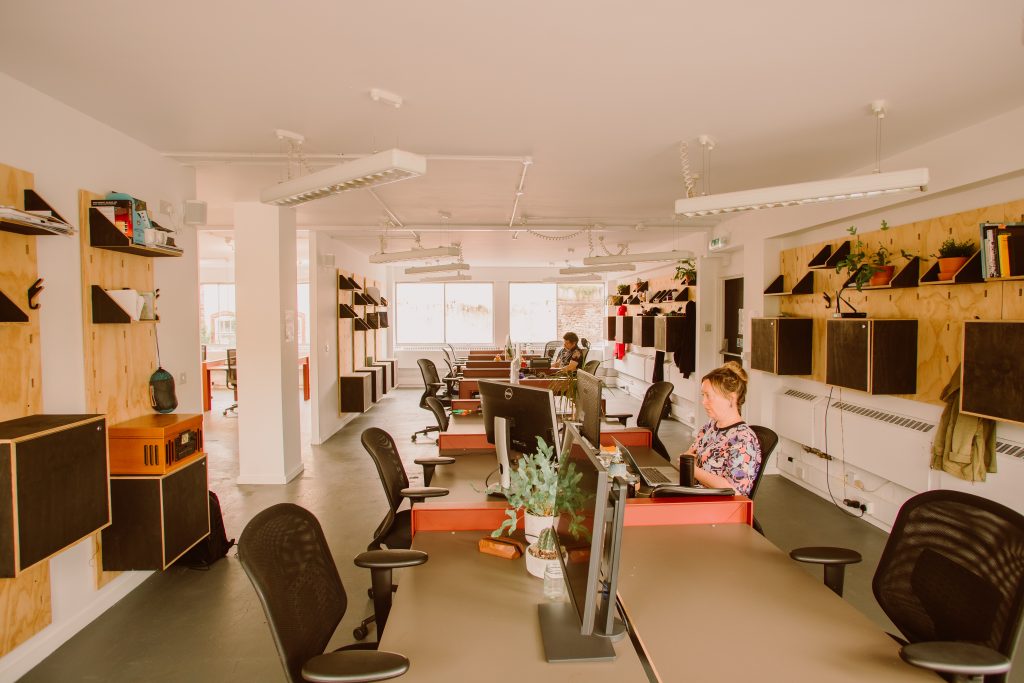 An office space with desks and people working