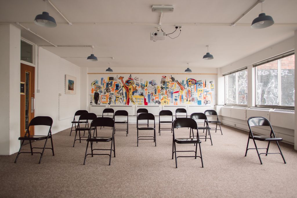 An event space with black chairs spread across the room