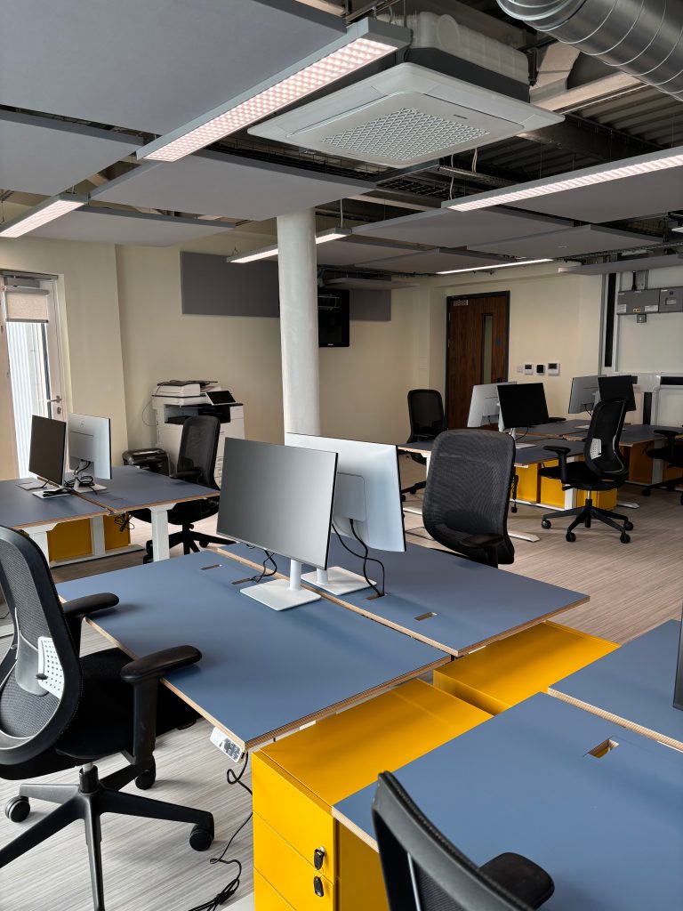An office space with desks and computers.