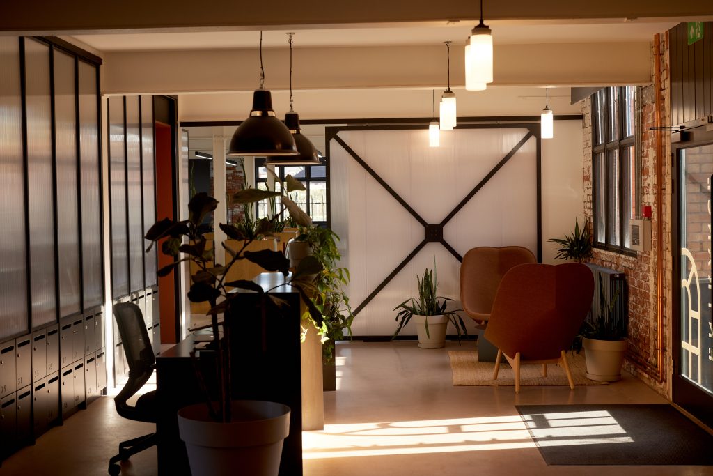 A reception area with natural light, a desk and seating