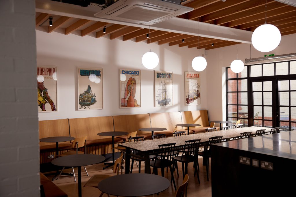 Bright and spacious cafe setup with bright lights and paintings