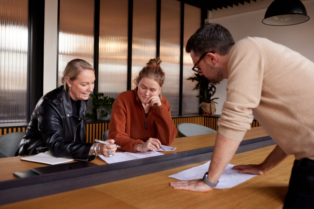A group of people around a conference room table