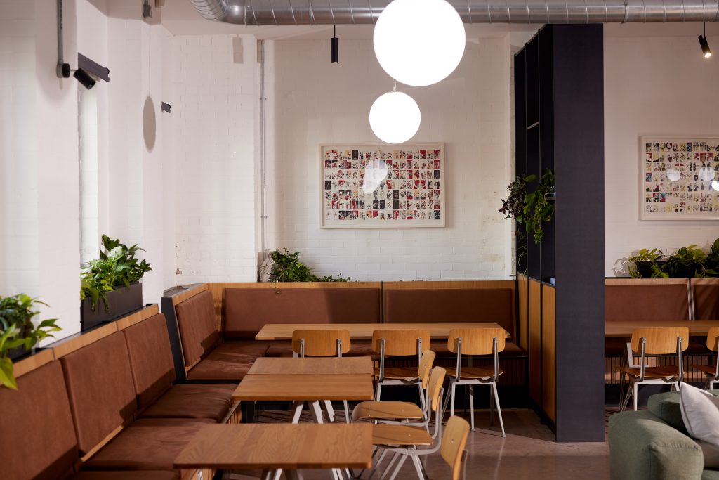 Wooden tables and chairs in a bright workspace