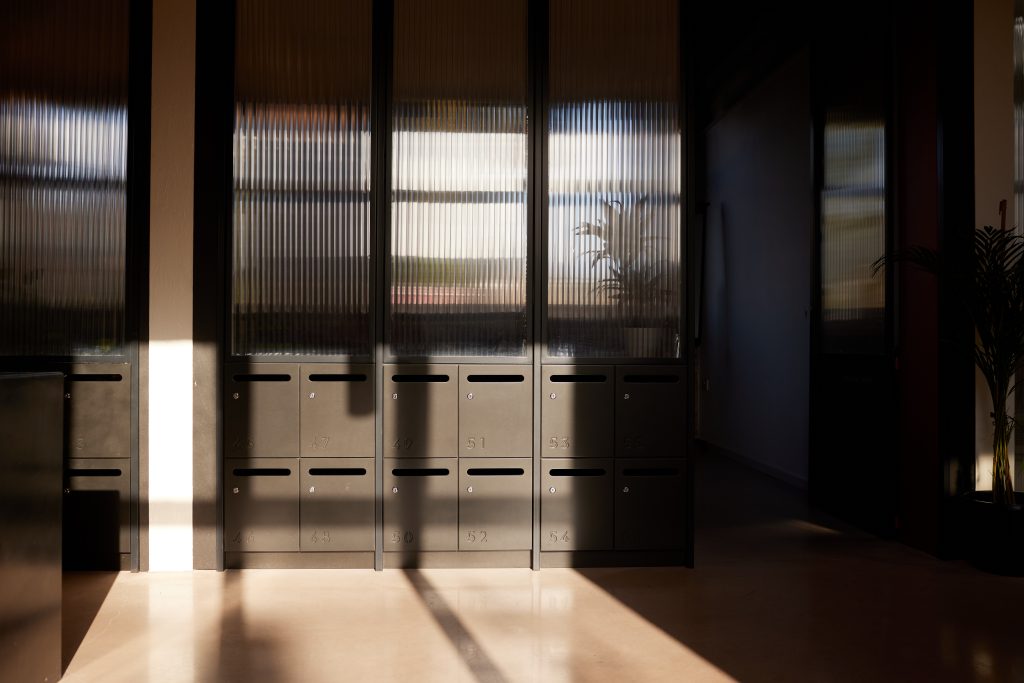 Numbered wooden mailboxes in an office reception