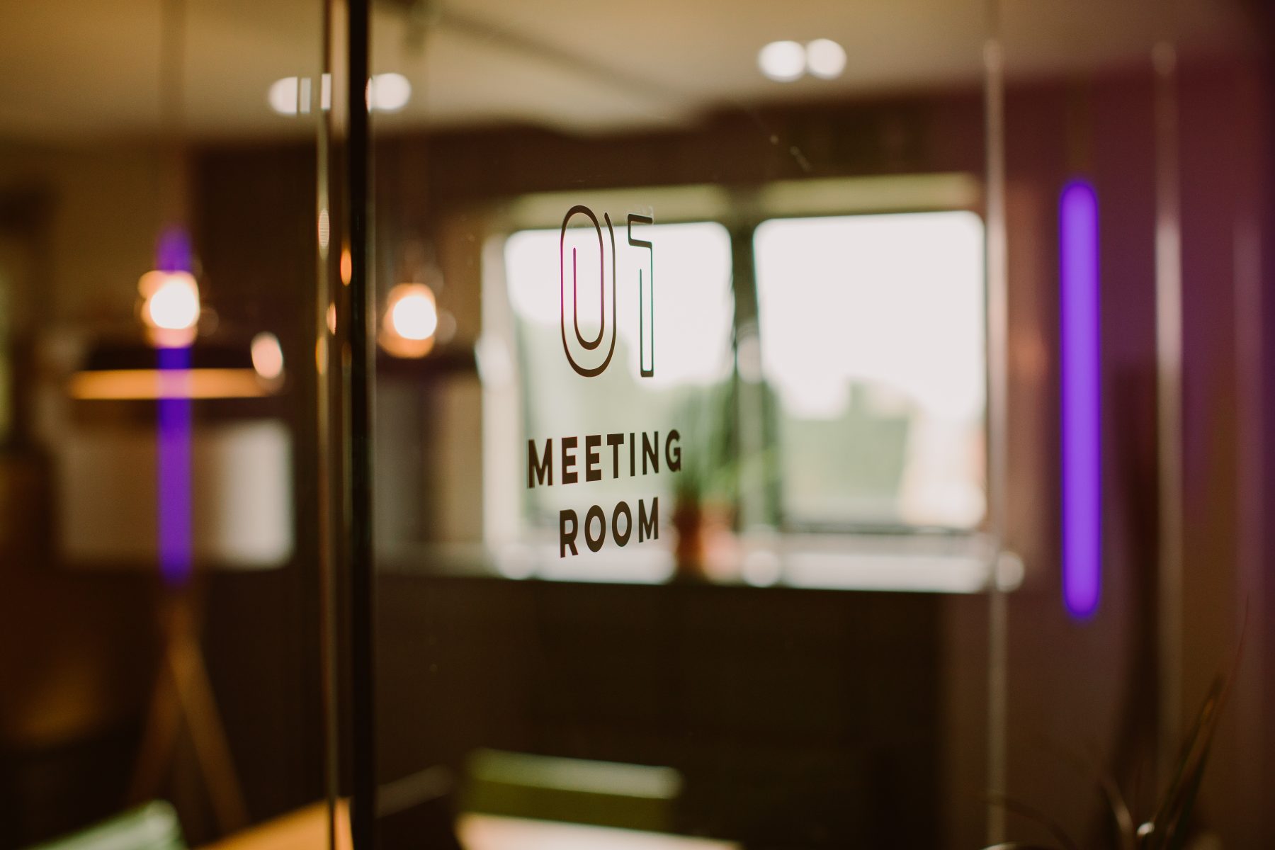 A glass door that says meeting room