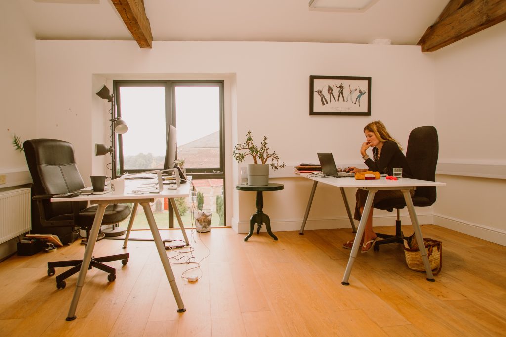 An office space with a woman sat at a desk