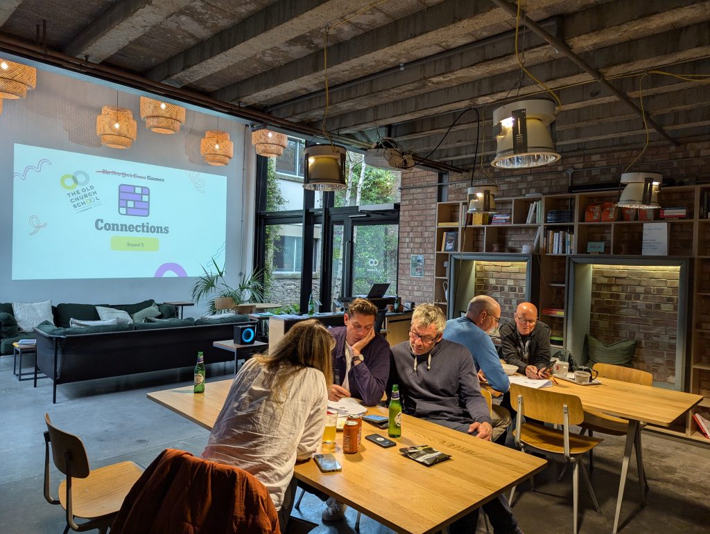 A group of people at tables and chairs doing a quiz